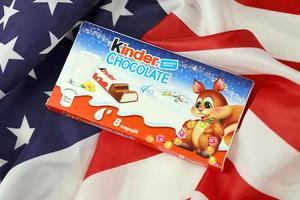 KHARKIV, UKRAINE - DECEMBER 16, 2021 Kinder Chocolate is a children dessert snack made by Italian confectionery brand Ferrero S.p.A. photo