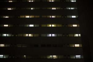 Windows in building at night. Unique architecture. photo