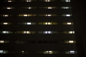 Windows in building at night. Unique architecture. photo