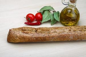 Baguette on wooden background photo