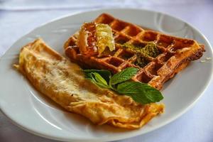 Belgian waffle on the plate and white background photo