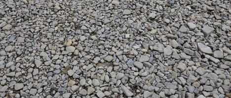 Texture of many crushed stones. Crushed stone is a solid base material for foundation photo