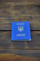 Photo of the Ukrainian foreign passport, lying on a dark wooden surface. The concept of introducing visa-free travel for Ukrainian citizens