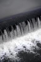 A picture of the flowing water. The dam is designed to regulate the water level in rivers within the city and to provide technical water to industrial objects photo