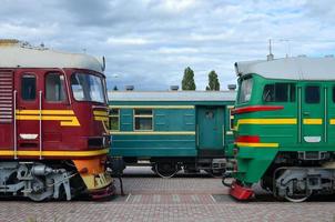 Cabs of modern Russian electric trains. Side view of the heads of railway trains with a lot of wheels and windows in the form of portholes photo