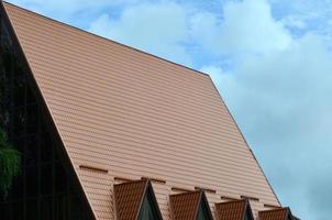 The house is equipped with high-quality roofing of metal tiles. A good example of perfect modern roofing. The building is reliably protected from adverse weather conditions photo