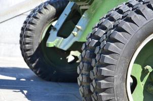 A close-up wheels of a portable weapon of the Soviet Union of World War II, painted in a dark green photo