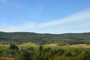 Photo of the Carpathian Mountains, which have a lot of coniferous trees. Forest and mountain landscape in the early autumn season