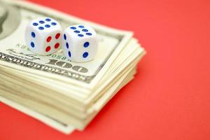 Money, finance and gambling concept. Close up on an American hundred US dollar banknotes and two white dice on top showing the numbers six photo