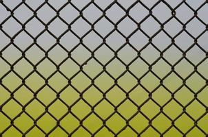 Texture of an old and rusty metal mesh on a neutral colored background photo