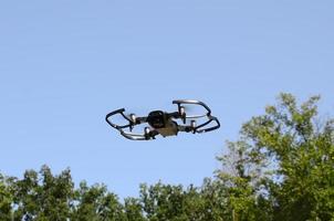 Drone with photocamera take off from land and flying for take aerial photo