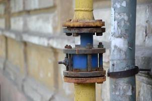 Yellow gas pipe in front of residential building wall photo