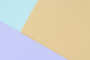 Texture background of fashion pastel colors. Violet, orange, and blue geometric pattern papers. photo