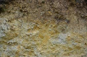 Texture of a wall of solid yellow and brown sand in a sandy quarry photo