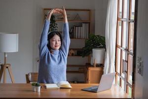 Relax, de-stress, vacation, have fun. Asian women take notes of their own past happily at home. photo