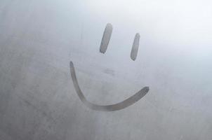 The inscription smile on the misted sweaty glass. Abstract background image photo