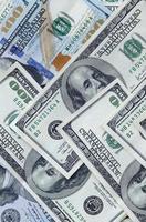 Abstract backdrop with many hundred dollar bills close up photo