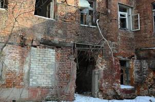 Fragment of an abandoned two-story building after military operations in Donetsk photo