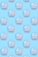 A lot of blue gift boxes lies on texture background of fashion pastel blue color paper in minimal concept photo