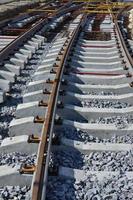 Fragment of tram rails at the stage of their installation and integration into the road. The process of laying a tramway photo