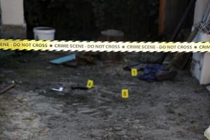 Crime scene tape for covering the area cordon. Yellow tape with blurred forensic law enforcement background in cinematic tone photo