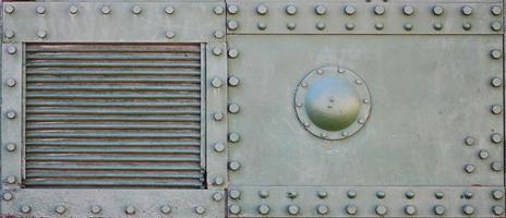 The texture of the wall of the tank, made of metal and reinforced with a multitude of bolts and rivets. Images of the covering of a combat vehicle from the Second World War photo