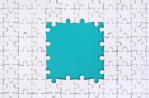 Framing in the form of a rectangle, made of a white jigsaw puzzle around the blue space photo