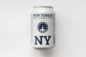 TERNOPIL, UKRAINE - JULY 18, 2022 Can of New Yorker fine lager beer with original logo and design on white paper background photo