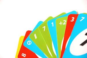 TERNOPIL, UKRAINE - MAY 15, 2022 Many colorful UNO game cards on white background. UNO is an American shedding-type card game that is played with a specially printed deck photo