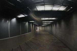 Dark interior of the underground passage with electric lighting photo