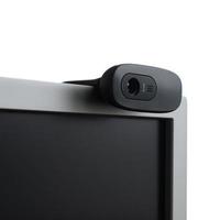 A modern web camera is installed on the body of a flat screen monitor. Device for video communication and recording of high quality video photo