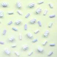 Colorful marshmallow laid out on lime paper background. pastel creative texture photo