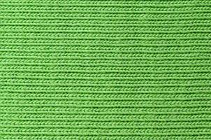 The texture of the fabric is bright green. Material for making shirts and blouses photo