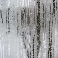 The texture of a misted glass with a lot of drops and condensation flows. Background image photo