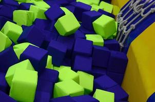 Many colorful soft blocks in a kids' ballpit at a playground photo