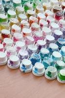 A pattern from a many nozzles from a paint sprayer for drawing graffiti, smeared into different colors. The plastic caps are arranged in many rows forming the color of the rainbow photo