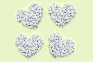 Colorful marshmallow laid out on lime and pink paper background. pastel creative textured hearts photo