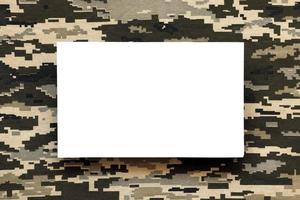 Fabric with texture of Ukrainian military pixeled camouflage and white blank paper. Cloth with camo pattern in grey, brown and green pixel shapes. photo