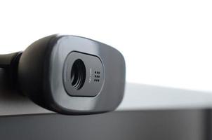 A modern web camera is installed on the body of a flat screen monitor. Device for video communication and recording of high quality video photo