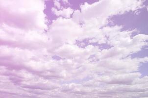 A blue sky with lots of white clouds of different sizes photo