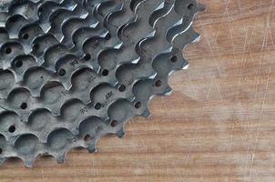 Rear cassette sprocket from a mountain bike lying on a wooden table in a bike shop photo