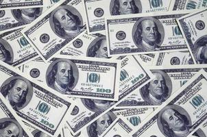 A pile of one hundred US banknotes with president portraits. Cash of hundred dollar bills, dollar background image with high resolution photo