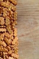 Many salted crackers on a cutting board with copy space photo