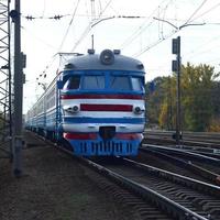 Old soviet electric train with outdated design moving by rail photo