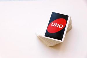 TERNOPIL, UKRAINE - MAY 15, 2022 Many colorful UNO game cards on white background. UNO is an American shedding-type card game that is played with a specially printed deck photo