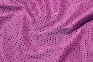 Texture of sportswear made of polyester fiber. Outerwear for sports training has a mesh texture of stretchable nylon fabric photo