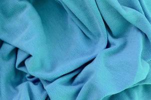 The texture of the fabric in blue color. Material for making shirts and blouses photo