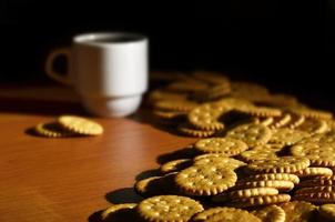 Small coffee cup and salted cracker photo
