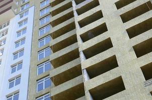 Residential multi store apartement building house facade under construction photo