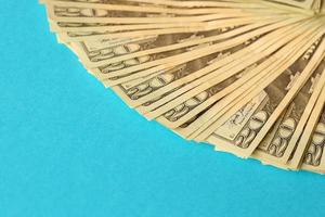 Big amount of old twenty dollar bills on blue background. Money earnings, payday or tax paying period photo